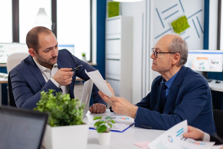 Senior Entrepreneur Discussing With Coworker Holding Documents Conference Briefing Businessman Discussing Ideas With Colleagues About Financial Strategy New Start Up Company 482257 5074